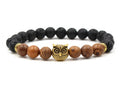 Bracelet with black and brown beads featuring an owl charm on a white background