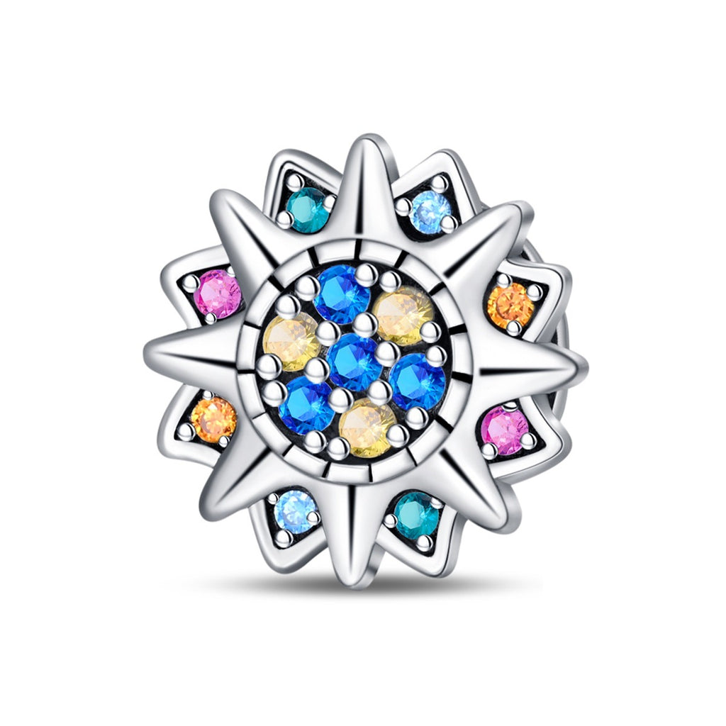 Silver charm with colorful gemstones on a white background