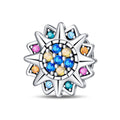 Silver charm with colorful gemstones on a white background