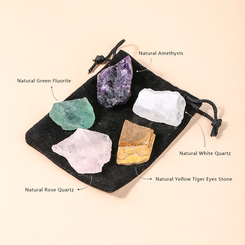 Set of natural crystals including green fluorite, amethyst, white quartz, rose quartz, and yellow tiger's eye on a black drawstring bag.