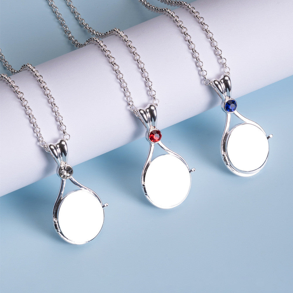 Three silver necklaces with circular pendants on a light blue background
