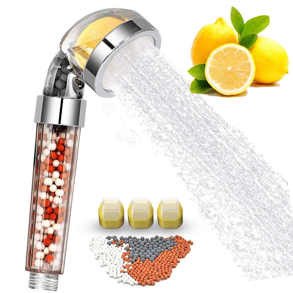Shower head with filtration beads, lemons, and water spray on a white background