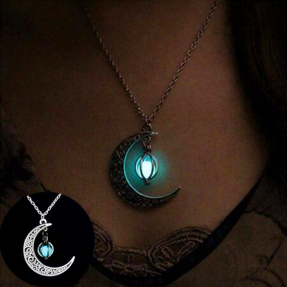 Glowing moon-shaped necklace on a person's neck with a close-up of the pendant.