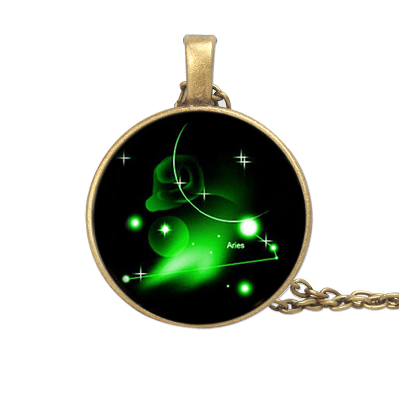 Pendant with green astrological design on a black background