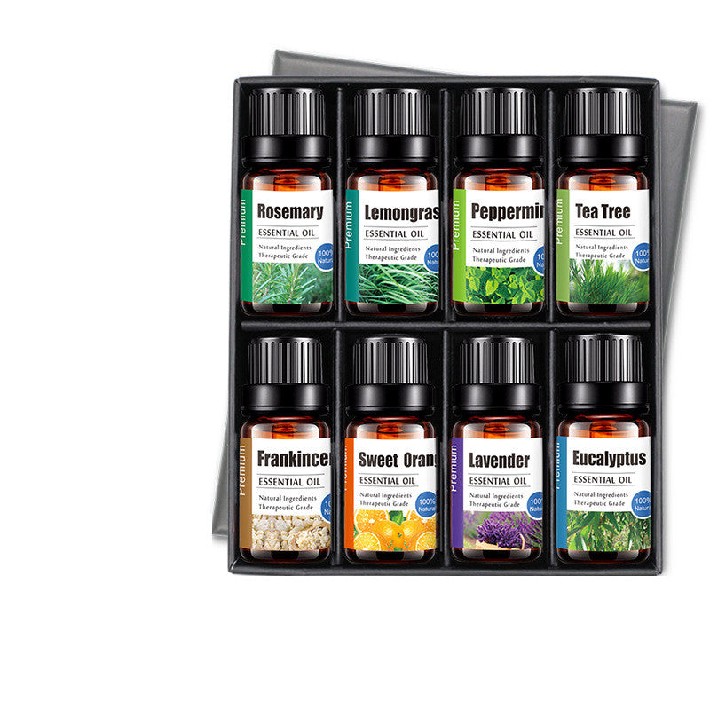 Set of essential oil bottles in a display box on a white background