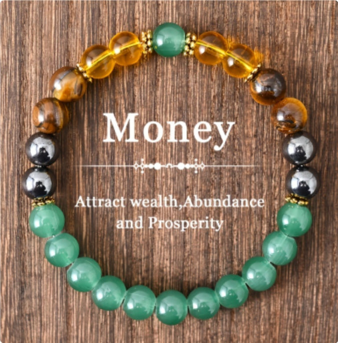 Beaded bracelet with colored beads on a wooden background, featuring text about attracting wealth, abundance, and prosperity.