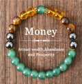 Beaded bracelet with colored beads on a wooden background, featuring text about attracting wealth, abundance, and prosperity.