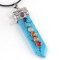 Turquoise pendant with colorful stones on a white background