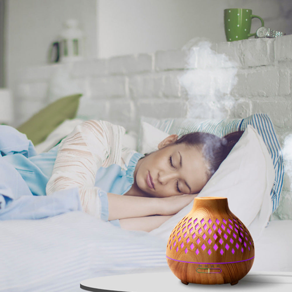 Woman sleeping in bed with a diffuser on the nightstand