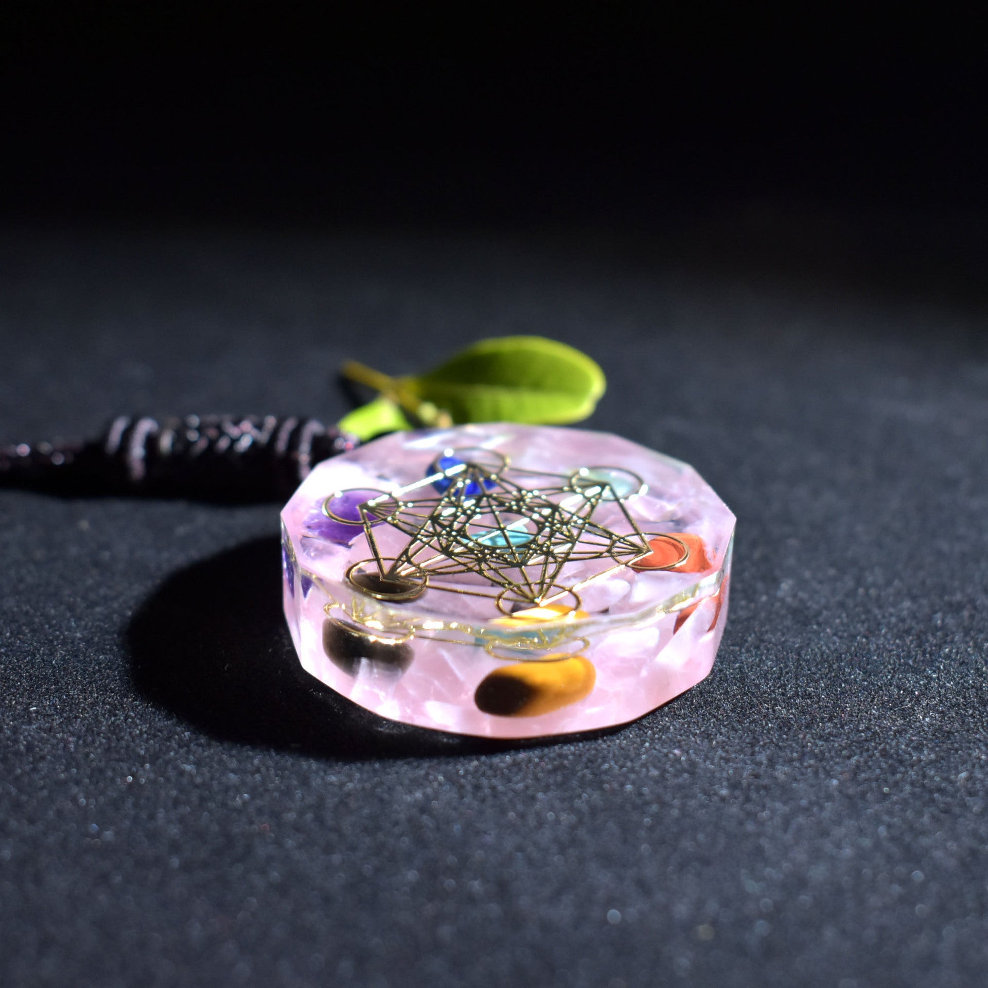 Crystal pendant with geometric design on a dark background