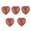 Five red heart-shaped stones on a white background