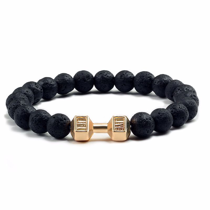 Black beaded bracelet with gold dumbbell-shaped charm on a white background