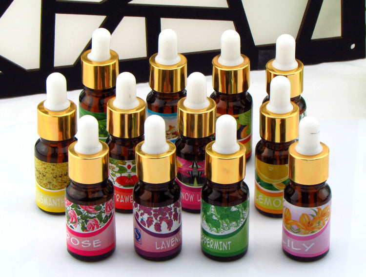 Collection of various essential oil bottles with dropper caps on a white background