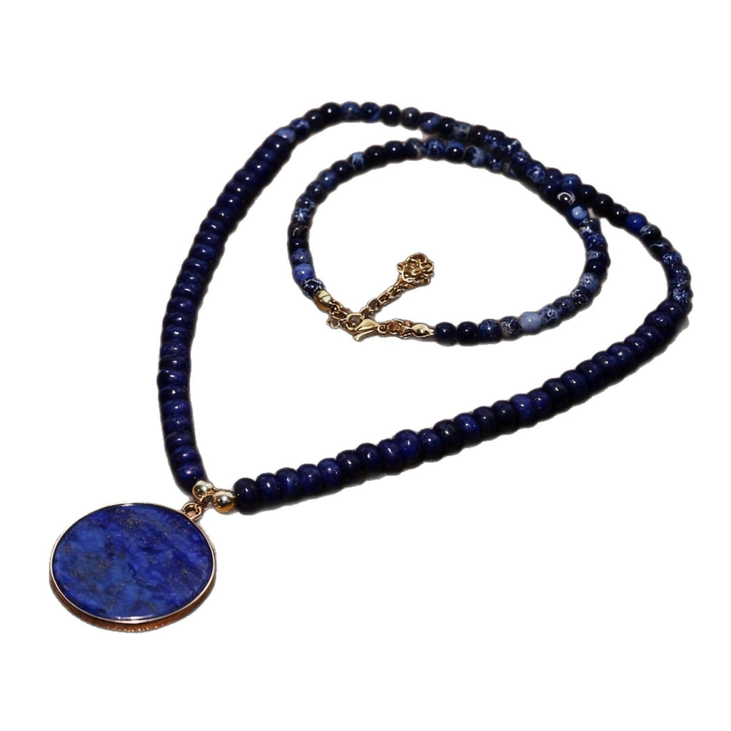 Blue beaded necklace with a round pendant on a white background