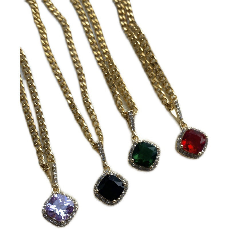 Four gold necklaces with colorful gemstone pendants on a white background
