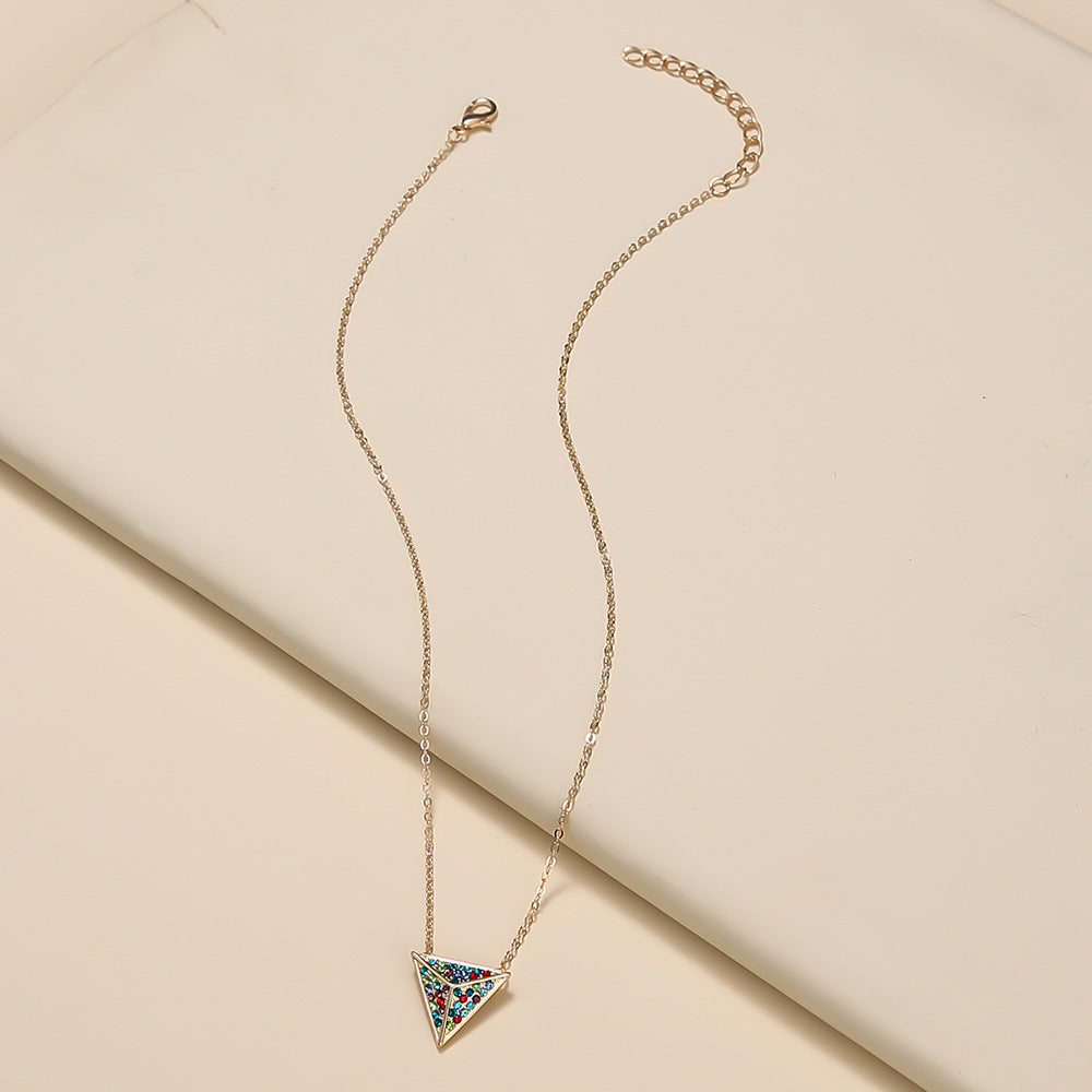 Necklace with a colorful triangle pendant on a beige background
