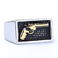 Ring with gold gun design on a black background