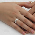 Hand wearing a silver ring on a white background