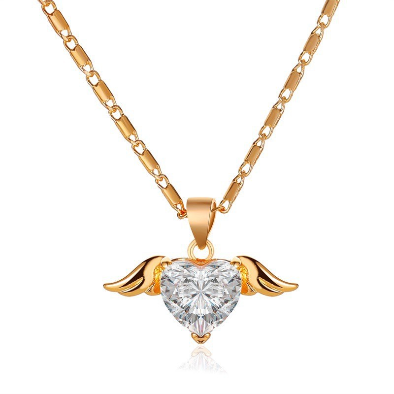 Gold necklace with a heart-shaped diamond pendant on a white background