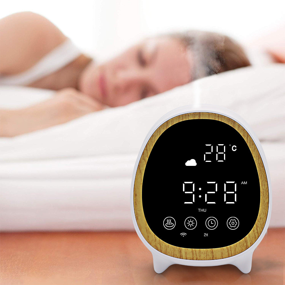Digital clock with wooden design displaying time and temperature, placed on a surface with a blurred background of a person lying down.