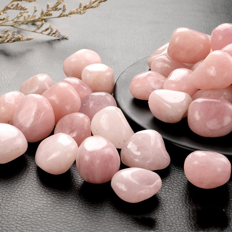 Pink stones on a dark surface with a subtle background