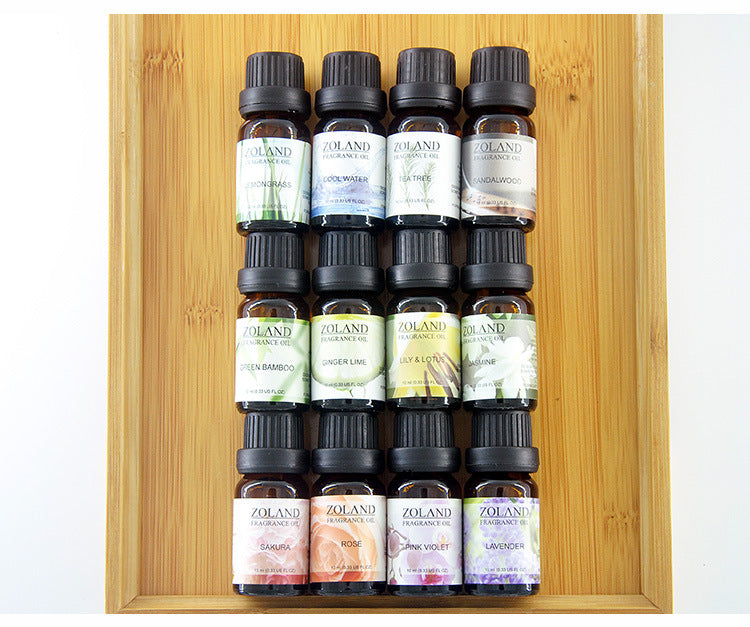 Set of Zoland essential oil bottles on a wooden tray