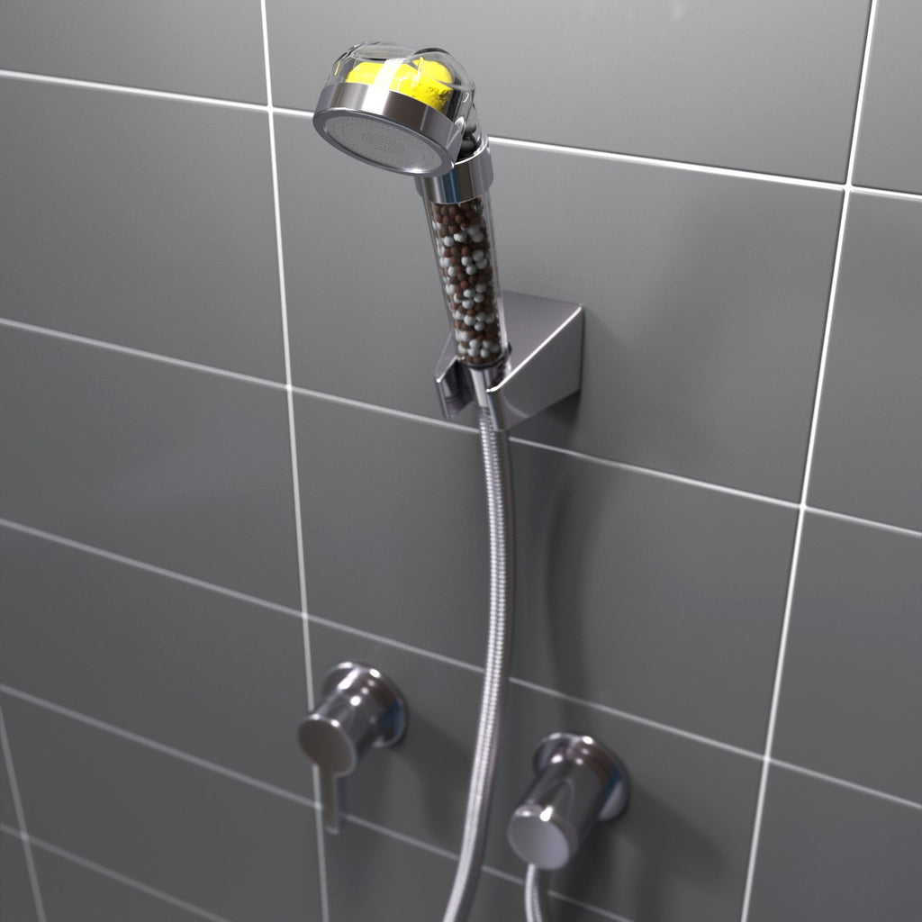 Shower head with hose attached to a tiled wall