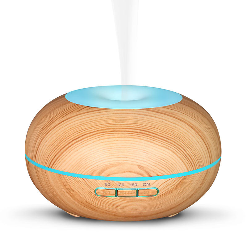 Wooden essential oil diffuser with blue accents on a white background