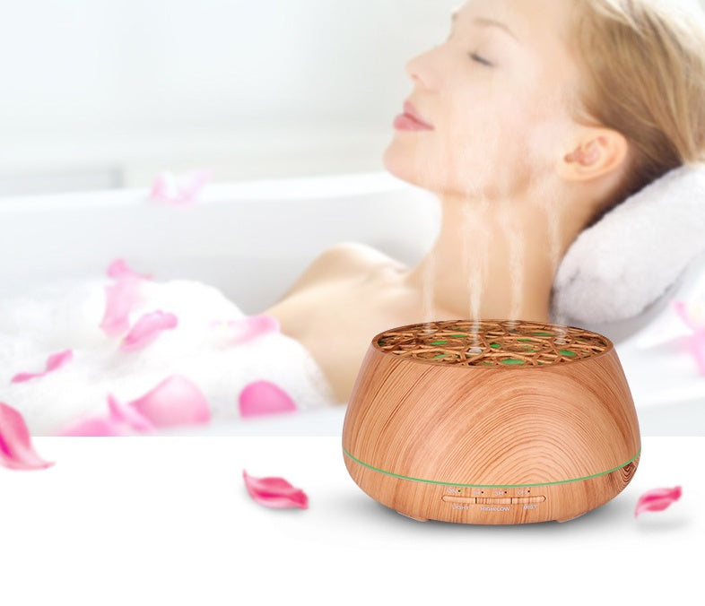 Wooden diffuser on a white surface with pink petals