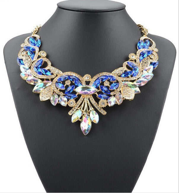 Elegant necklace with blue and gold stones on a black mannequin