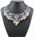 Elegant necklace with blue and gold stones on a black mannequin