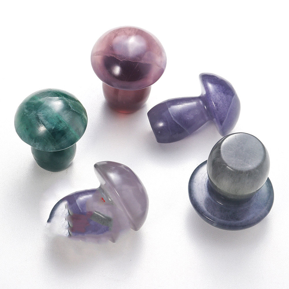 Set of colorful glass bottle stoppers on a white background