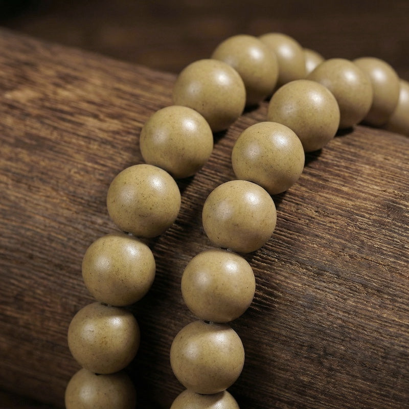 Beige beads on a wooden surface