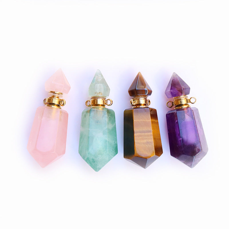 Four crystal perfume bottles in different colors on a white background