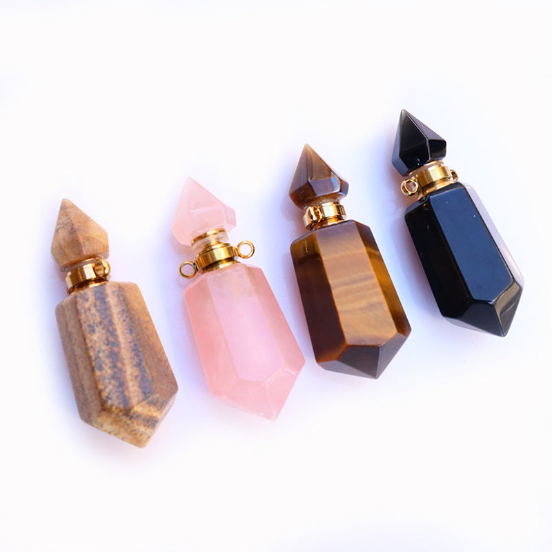 Four decorative bottles with geometric shapes and gold caps on a white background