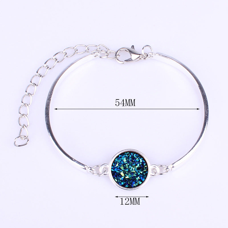 Silver bracelet with a blue gemstone, shown on a white background with measurements indicated.