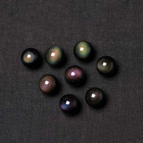 Set of dark pearls on a black fabric background
