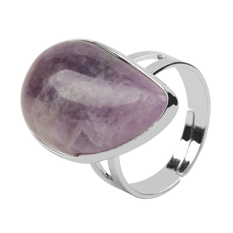 Ring with a purple stone and silver band on a white background