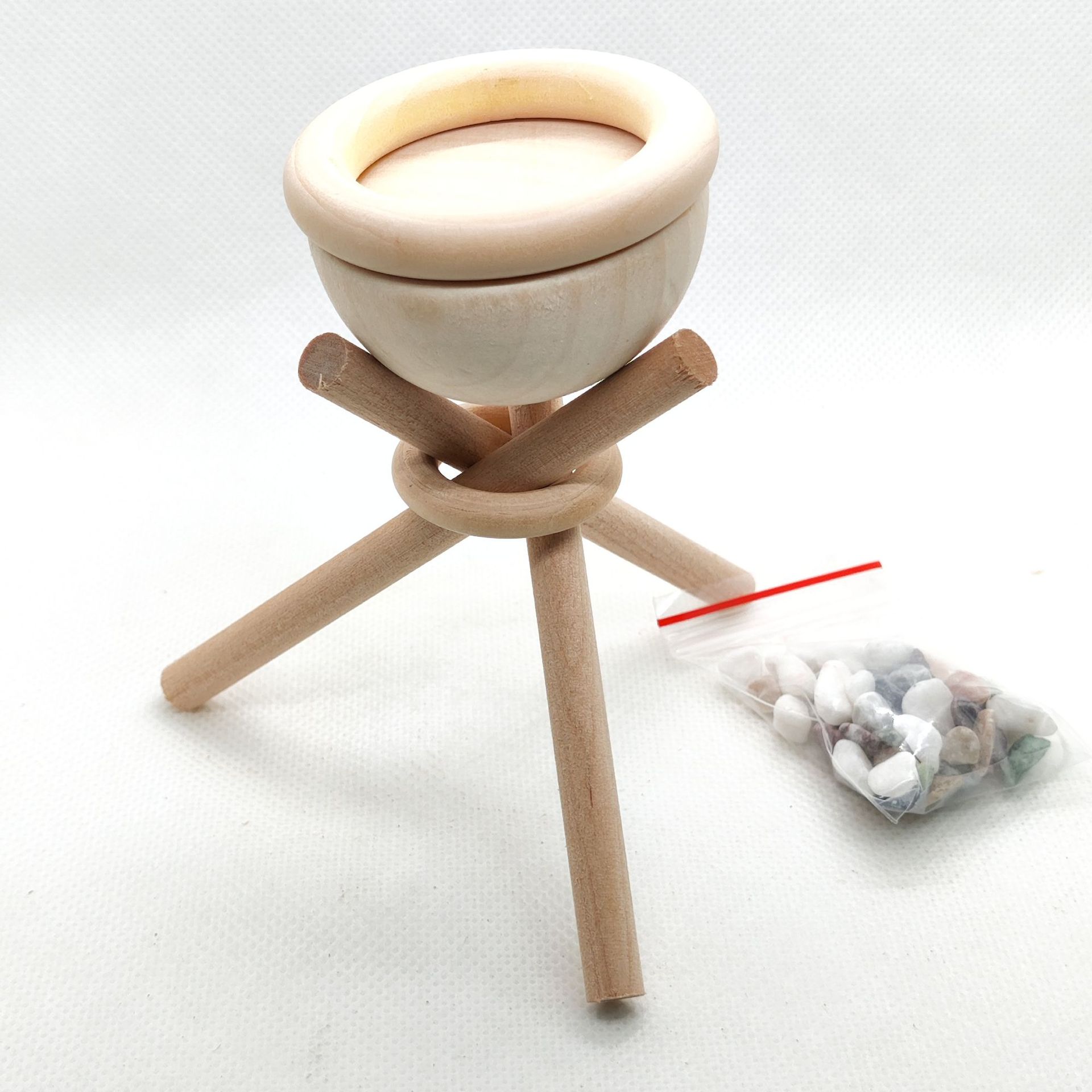 Wooden incense burner with a tripod design on a white background