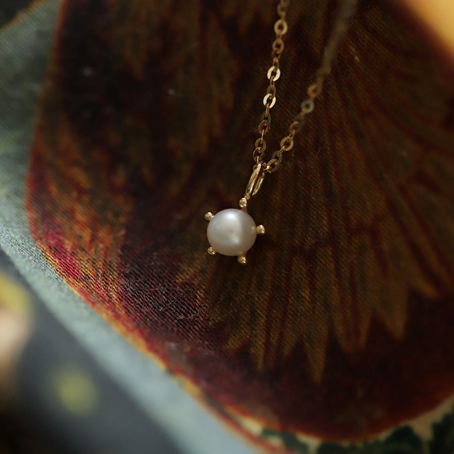 Pearl necklace on a textured fabric background