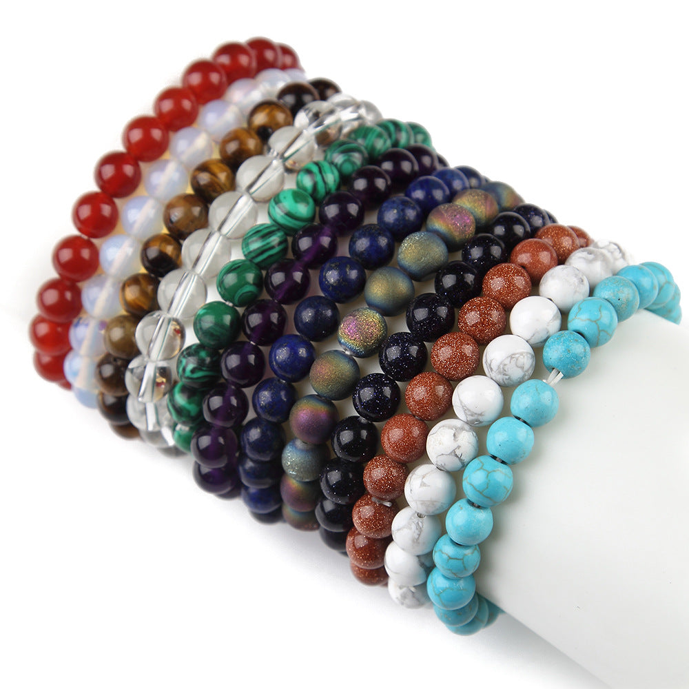 Stack of colorful beaded bracelets on a white background