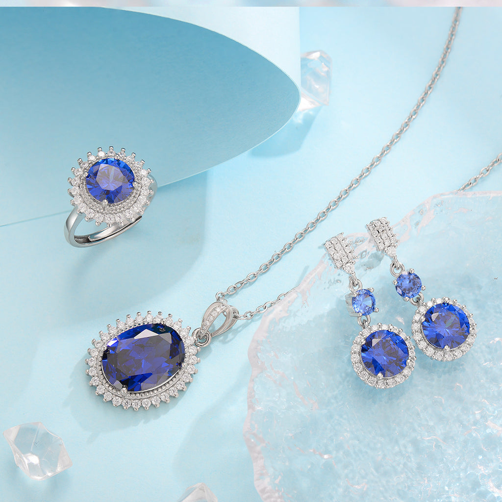 Jewelry set with blue gemstones on a light blue background