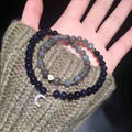 Beaded bracelets on a hand with a textured surface background