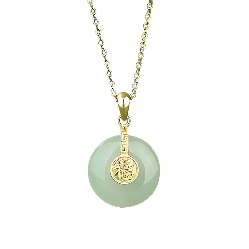 Necklace with a green jade pendant and gold accents on a white background