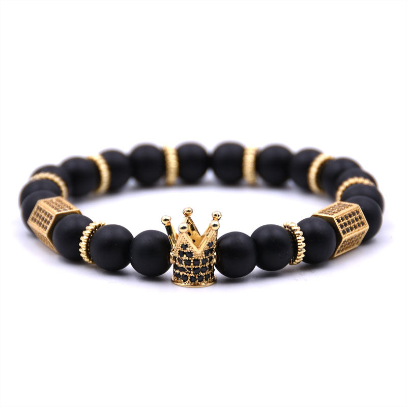 Black beaded bracelet with gold accents and a crown charm on a white background