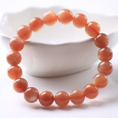 Orange beaded bracelet on a white background