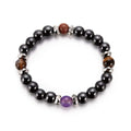 Beaded bracelet with black, brown, and purple beads on a white background
