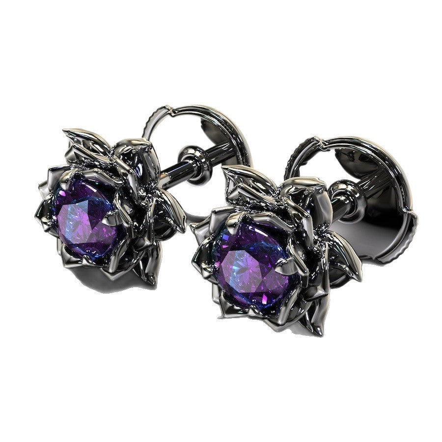 Pair of silver earrings with purple gemstones on a white background