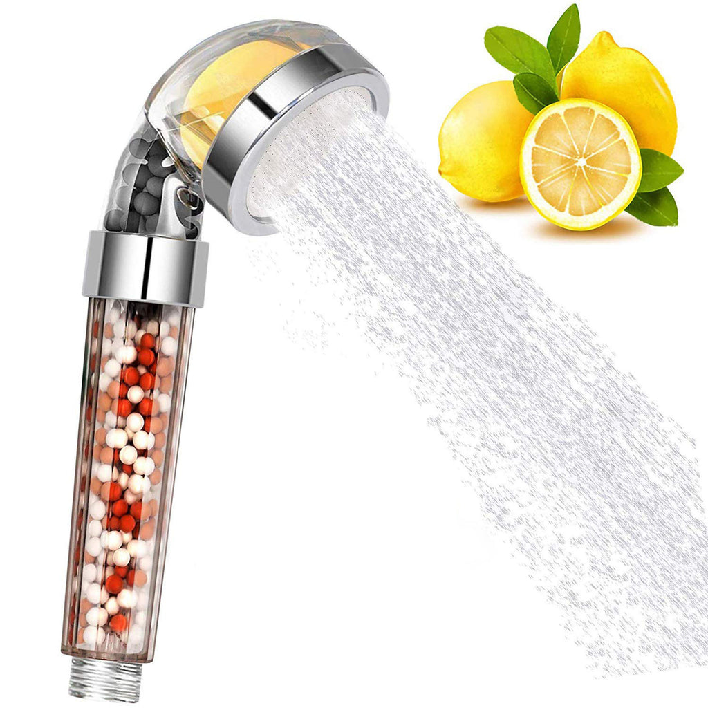 Handheld shower head with lemon and peppermint balls, emitting water, with lemons on a white background.