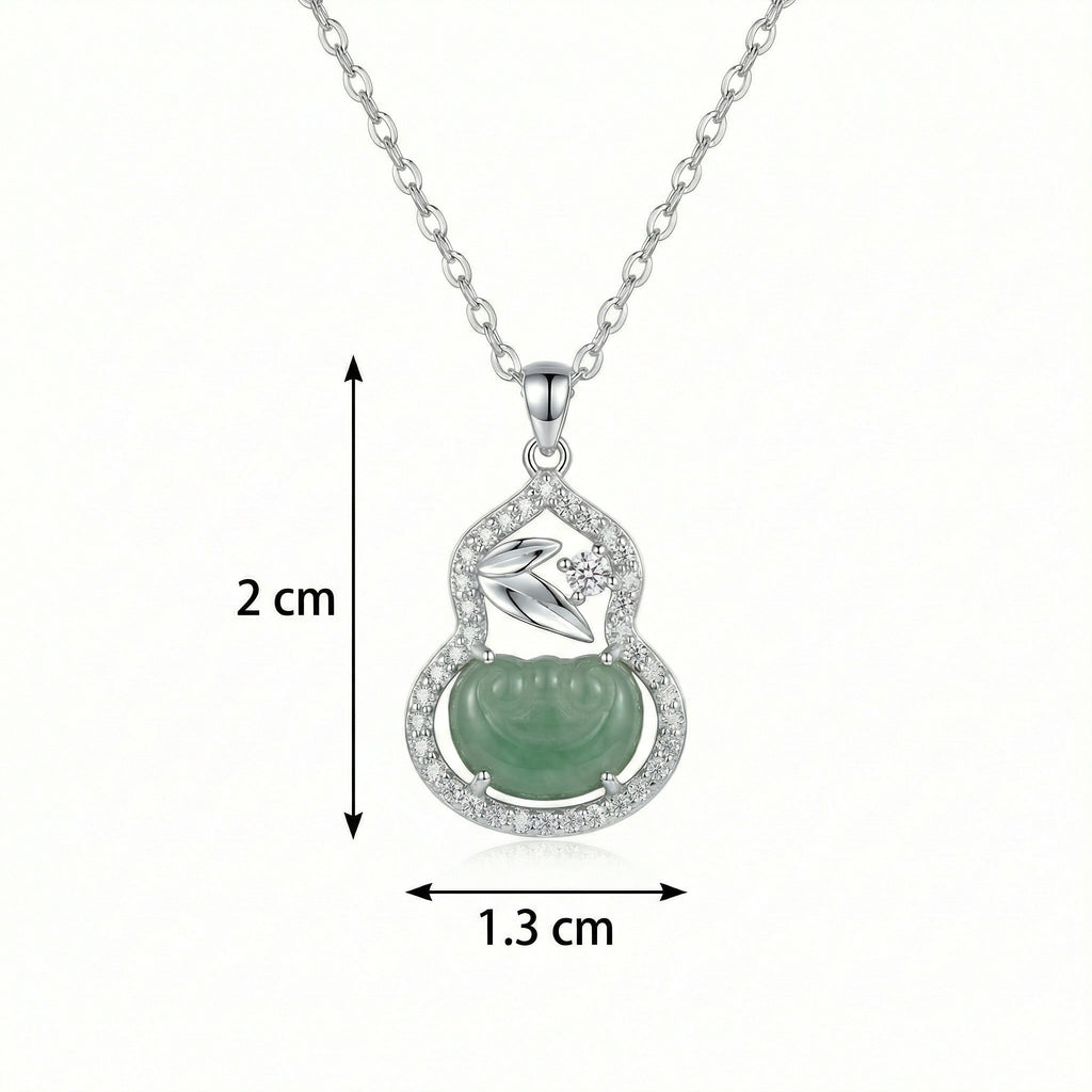 Silver necklace with a green pendant and measurements on a white background